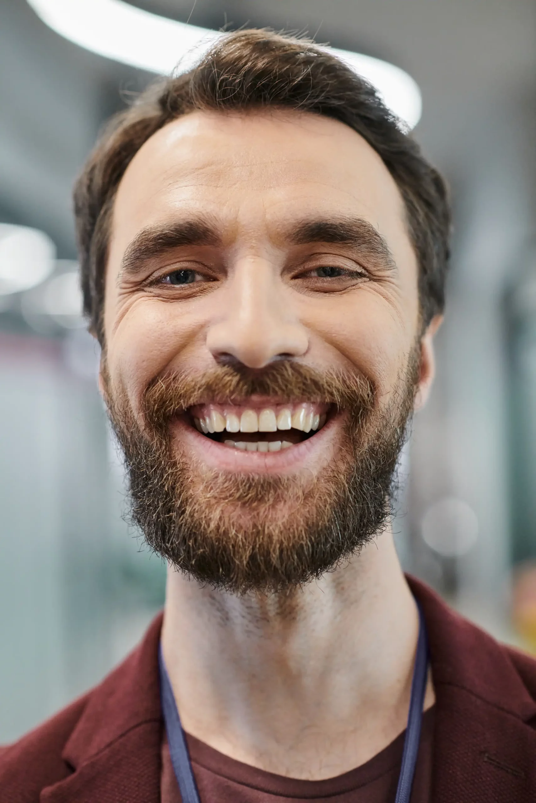 A smiling man with a beard in an office.